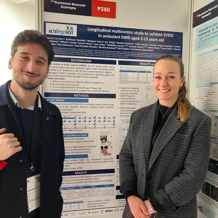 Sysnav Healthcare team smiling in front of a scientific poster on DMD at the International Congress of Myology 2024