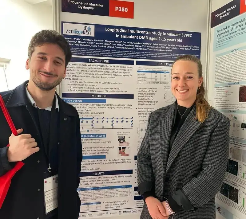 Sysnav Healthcare team smiling in front of a scientific poster on DMD at the International Congress of Myology 2024